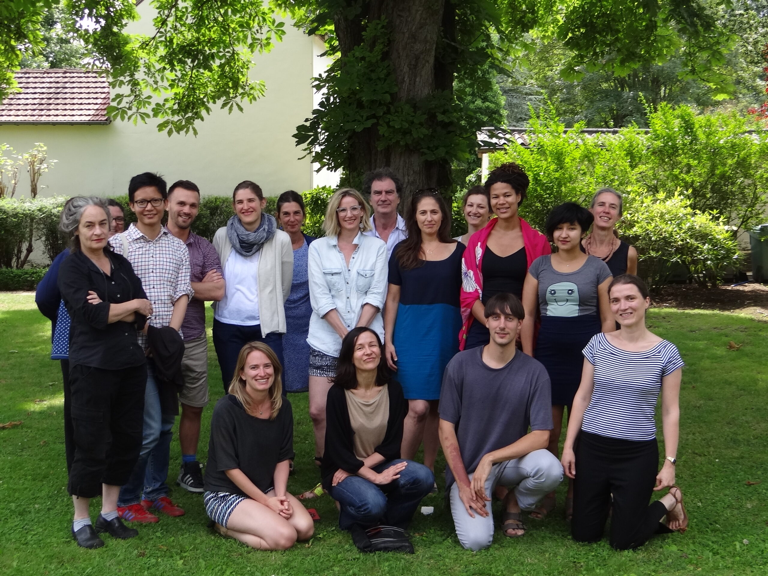 A group of people in a garden, posed for a photograph.