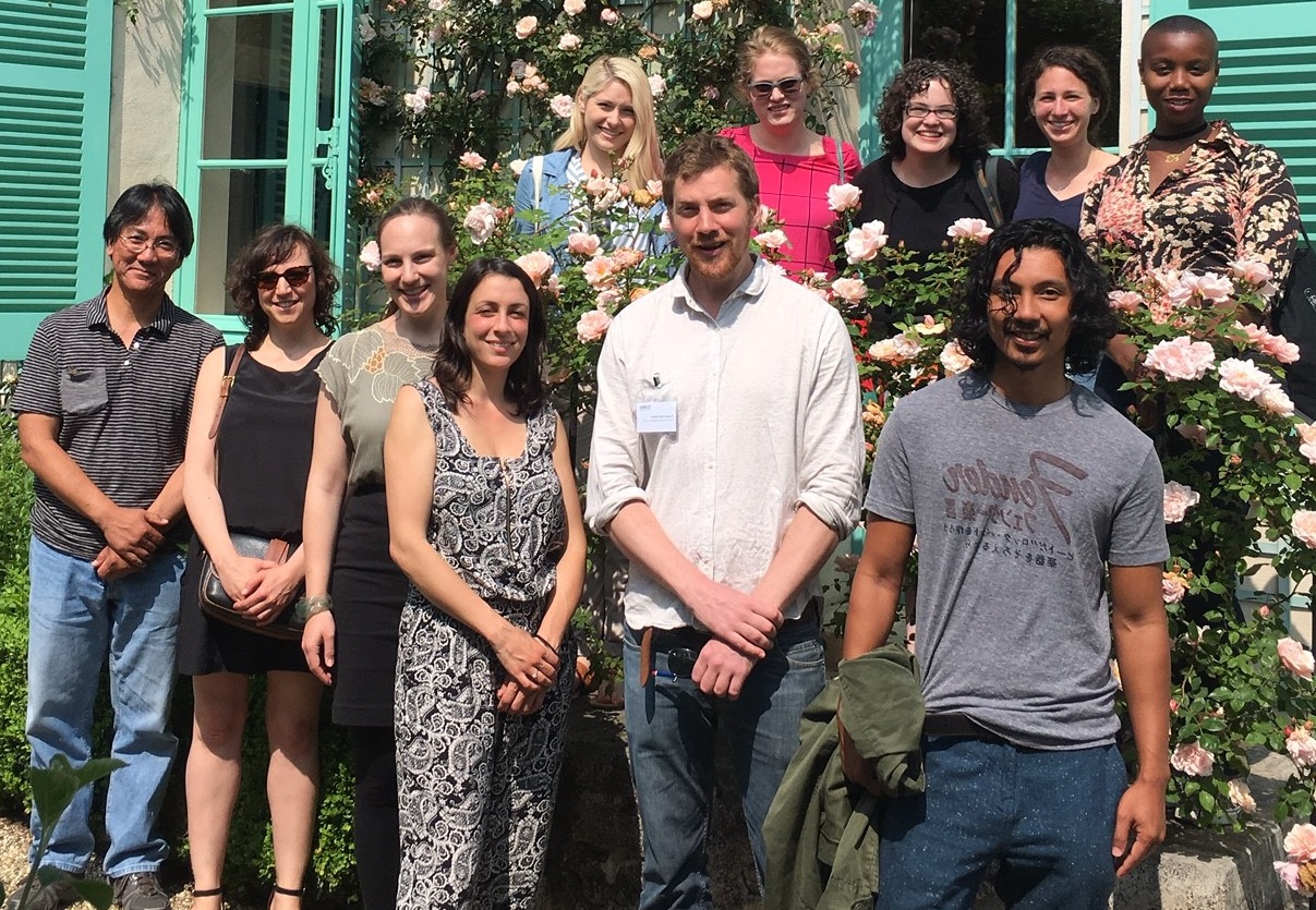 A group of people in a garden, posed for a photograph.