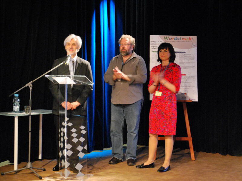 Three people standing at a podium.