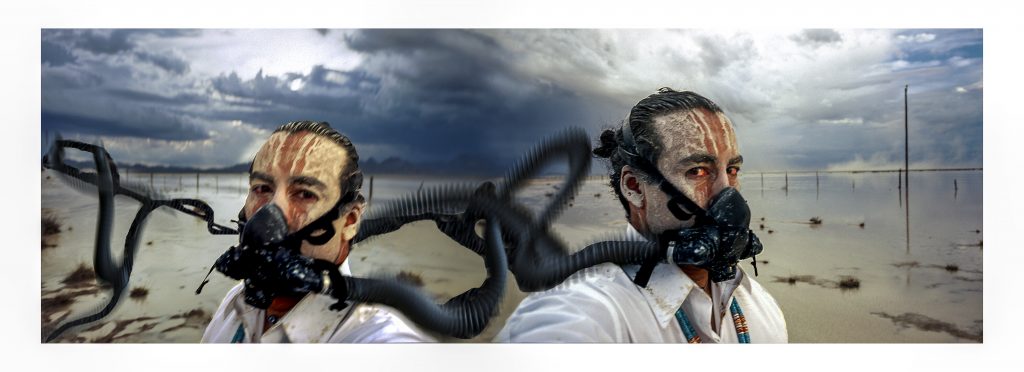 Photograph of a man wearing a gas mask, which appears as a mirror image of two men wearing gas masks.