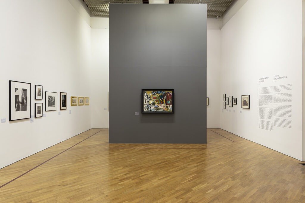 Installation photograph of framed paintings on three walls.