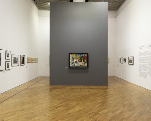 Installation photograph of framed paintings on three walls.