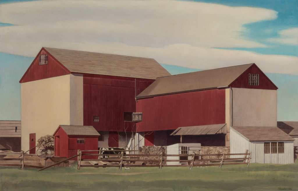 A red barn against a blue sky.