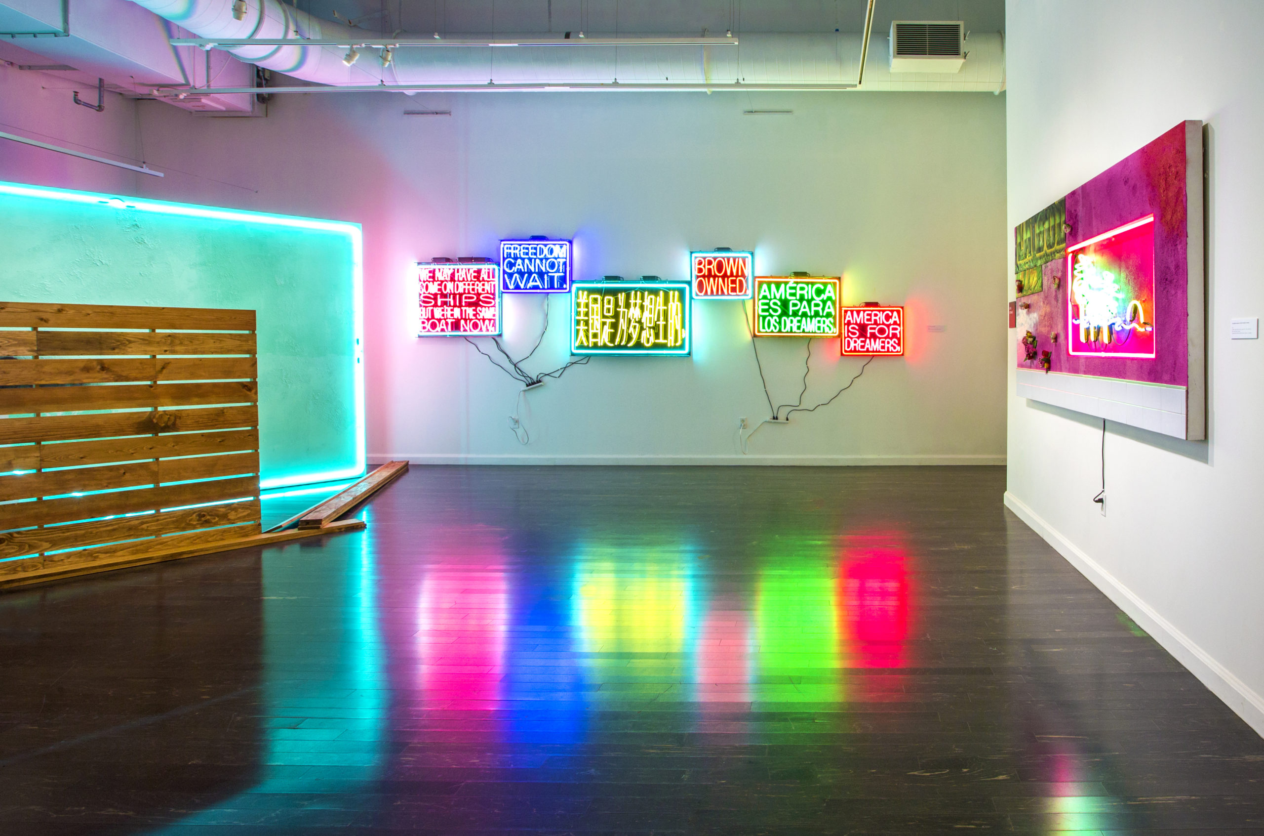 Artwork featuring neon lights installed in a gallery space.