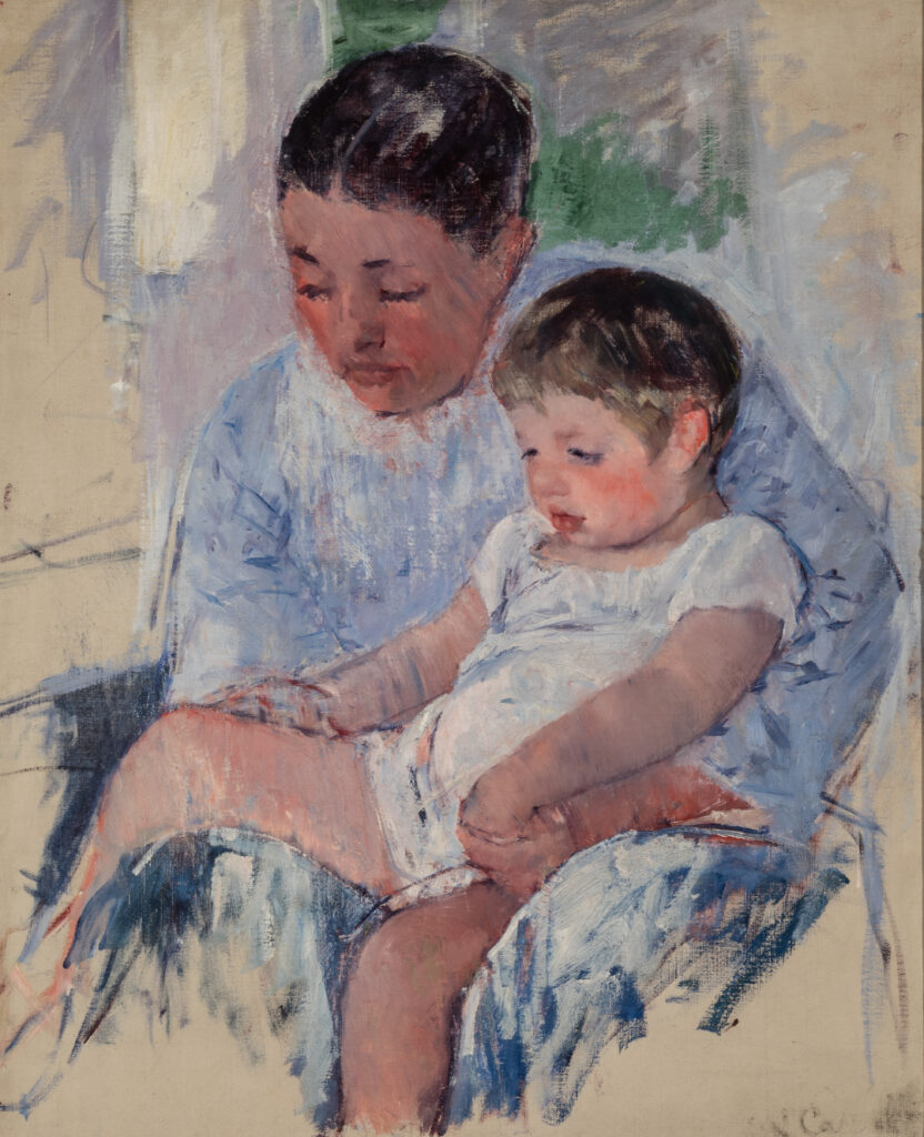 A seated woman with a child in her lap.