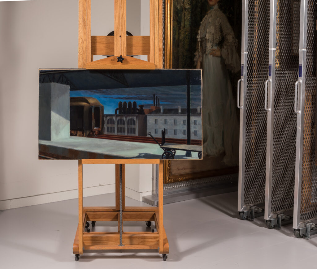 Edward Hopper's painting Dawn in Pennsylvania (1942) on an easel in front of other Terra Foundation artworks.