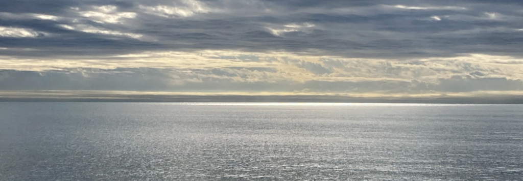 An image of sunrise over an ocean or large body of water.