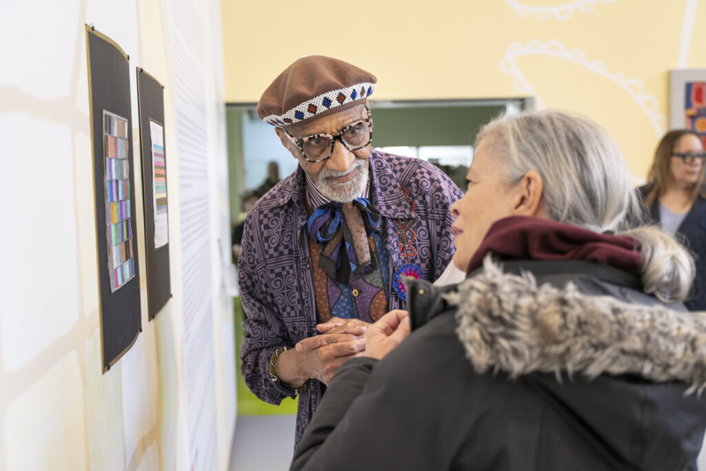 Robert Earl Paige speaks with a gallery visitor to the exhibition.