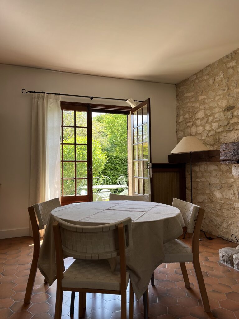 Goupil House dining table and door open to the patio.