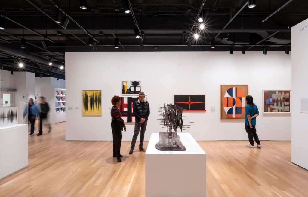 Gallery installation with people viewing art.