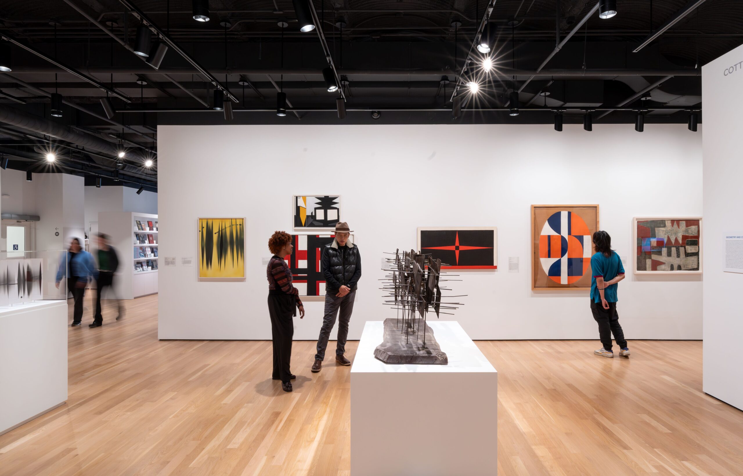 Gallery installation with people viewing art.