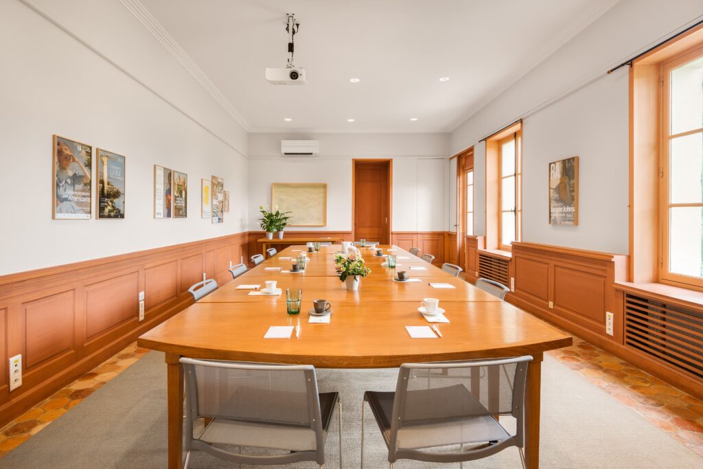 Hameau House seminar room with long wood table.
