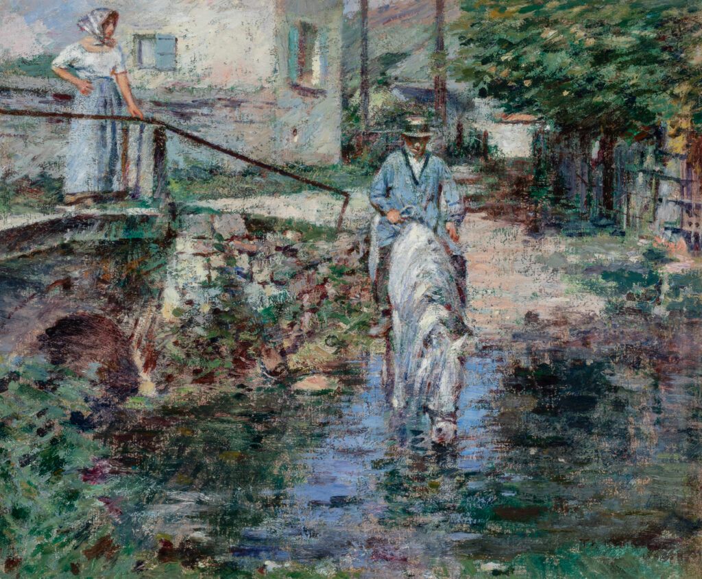 A man sits on a horse by a river. A woman stands on a bridge that spans the river.