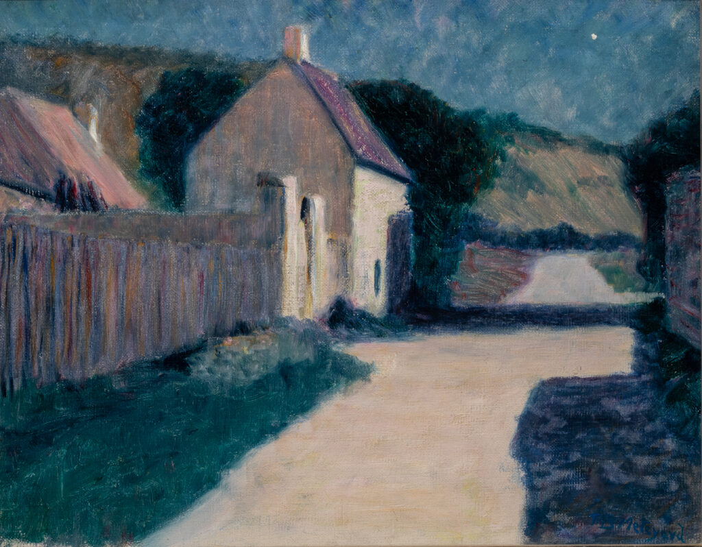 A view of a road through a village at night.