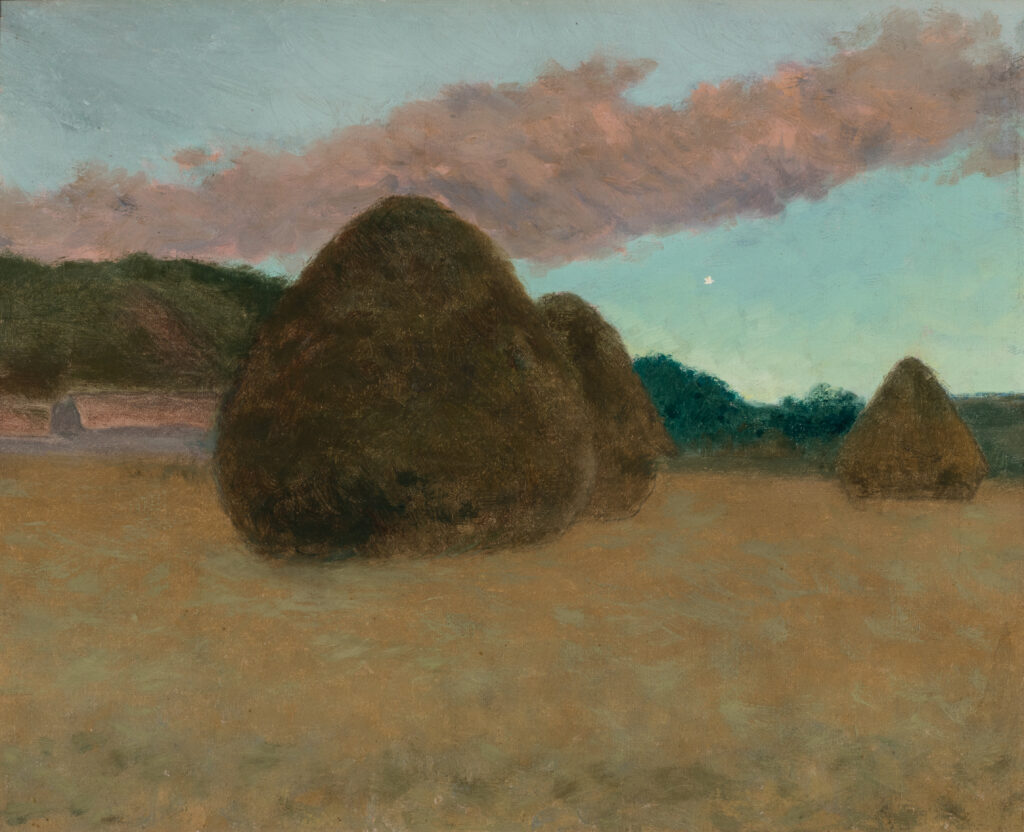 Three haystacks in a field.