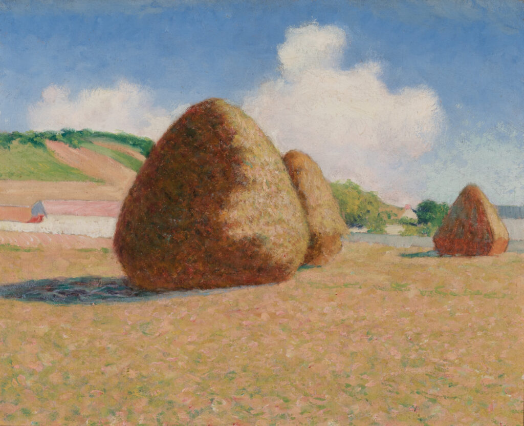 Three haystacks in a field.