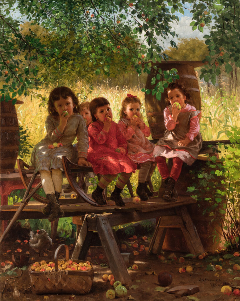 Five young children sit in an apple orchard eating apples.