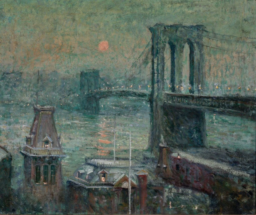 A view of the Brooklyn Bridge in New York City at night.
