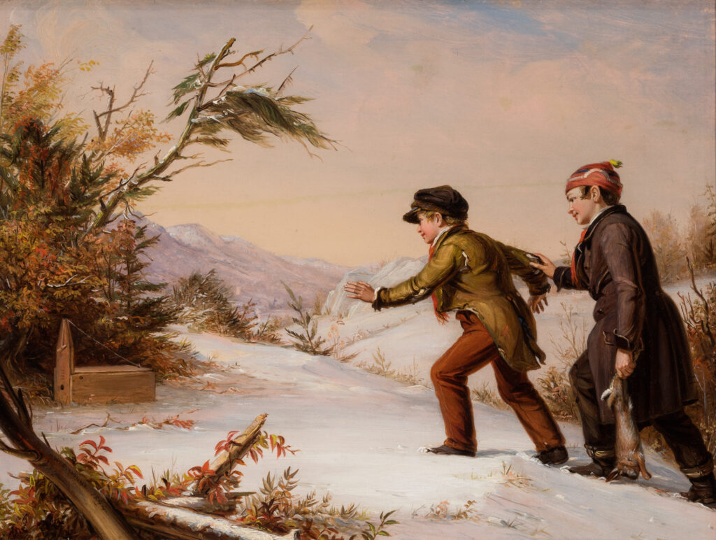 Two boys walk through a snowy landscape toward an animal trap they laid.