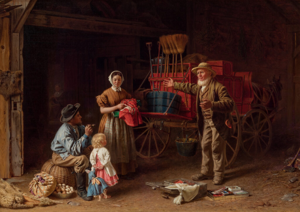 A group of people standing in a barn.