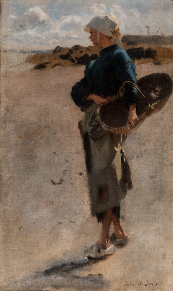 A woman standing on the beach holding a basket.