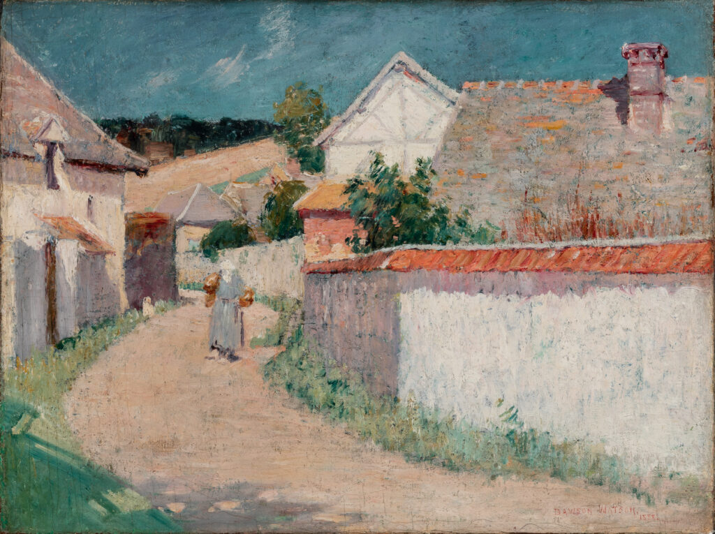 A road through a village. A woman walks in the road.