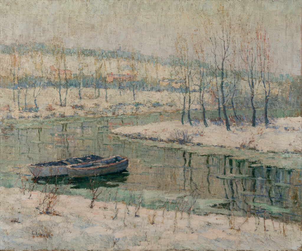 A wintry scene of a river winding through a forest of bare trees.