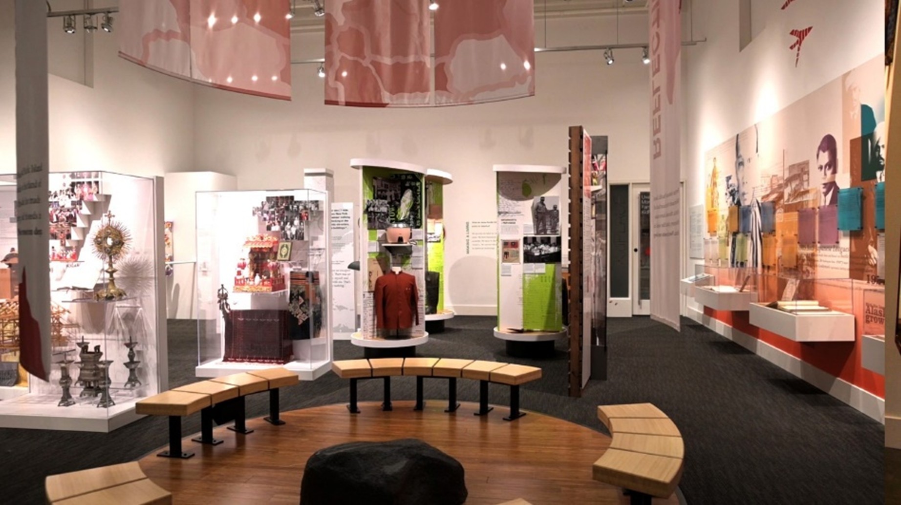 Gallery installation view including many vitrines.