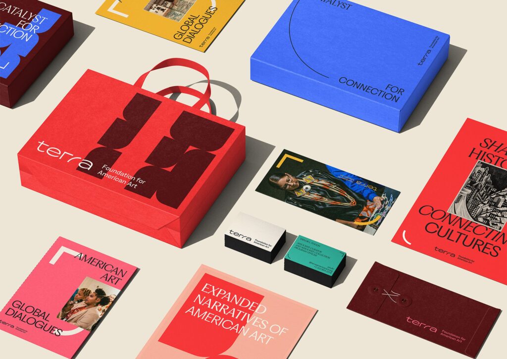 A variety of brand collateral in various colors, including cherry, pink, mint, dark brown, cobalt, brass, and salmon.