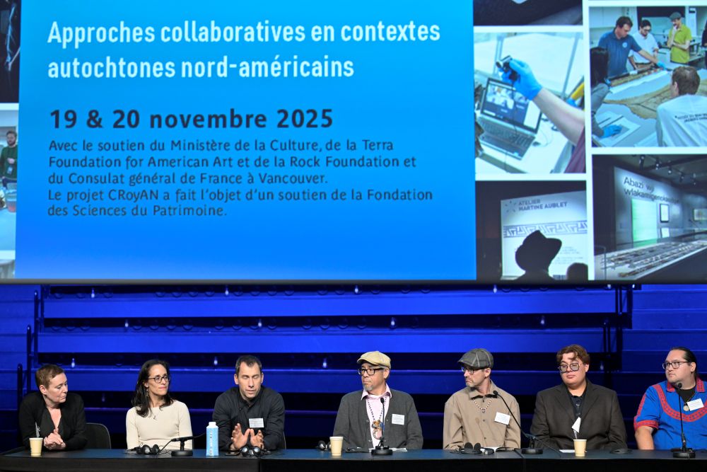 The stage of a conference with panel members on it.