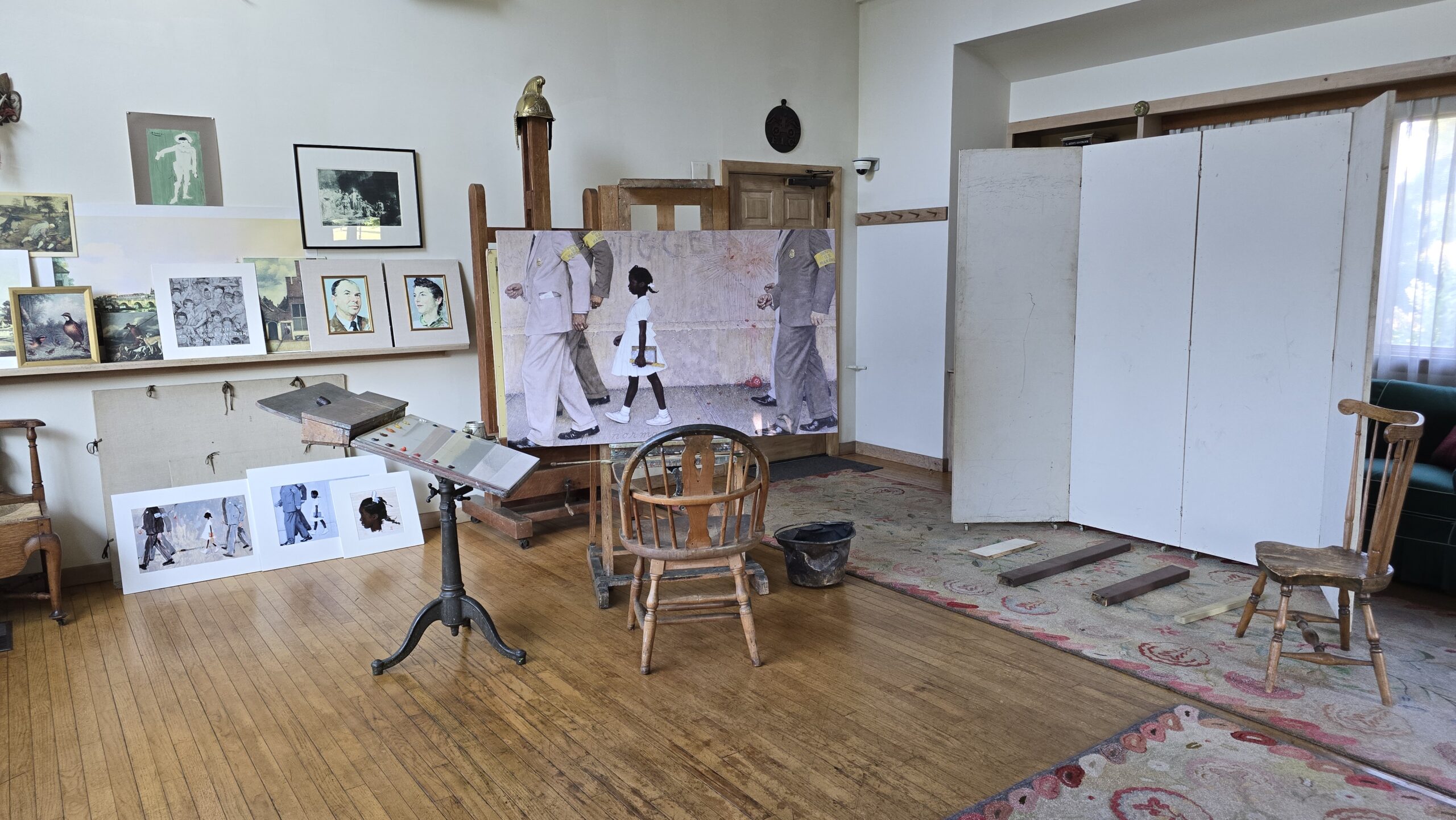 Installation restaging of Norman Rockwell’s studio in 1963, with his painting The Problem We All Live With on an easel in the center of the studio.